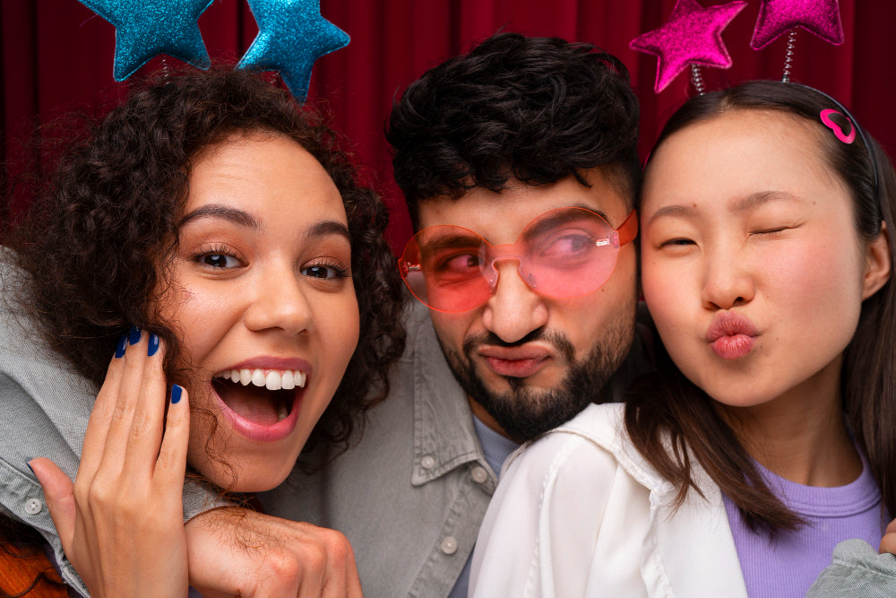 Group of friends posing inside a classic photo booth at a Dallas party
